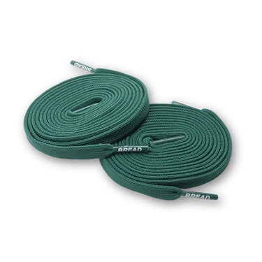 Sea green elastic shoelaces coiled neatly, featuring a textured surface and branded tips.