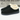 Men's Ashton slipper in black suede with a soft cream fur lining, featuring a low-profile design and rubber sole.
