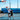 Two men playing basketball on an outdoor court, one shooting while the other defends.
