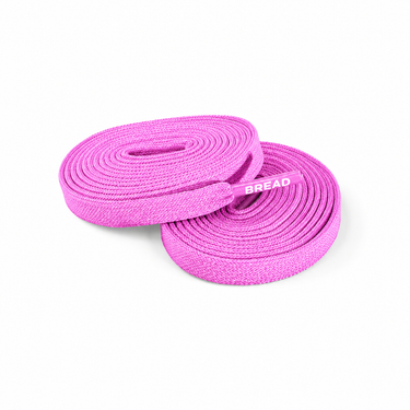 Two coiled pink fabric elastic shoelaces with BREAD printed on the plastic aglets.