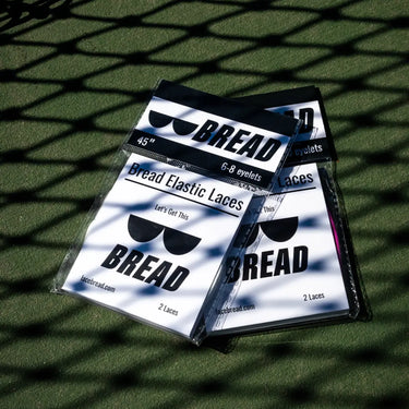 Flat lay of Bread Laces packaging on green turf surface