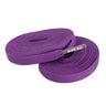 Two coiled purple fabric shoelaces with clear aglets printed with BREAD in white text.