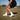Cloud White elastic shoelaces displayed on a person wearing black shorts and white socks, standing on grass.