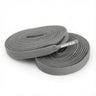 Two coiled gray fabric shoelaces with BREAD printed on the plastic tip.