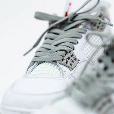 Vulture gray elastic shoelaces on a white sneaker with textured details and light gray laces.